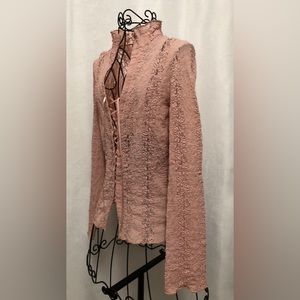 Light pink lace top with lace up front. Long sleeve.